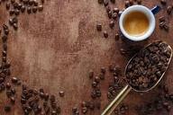 Cup of hot coffee on wooden table at The Daily Cafe